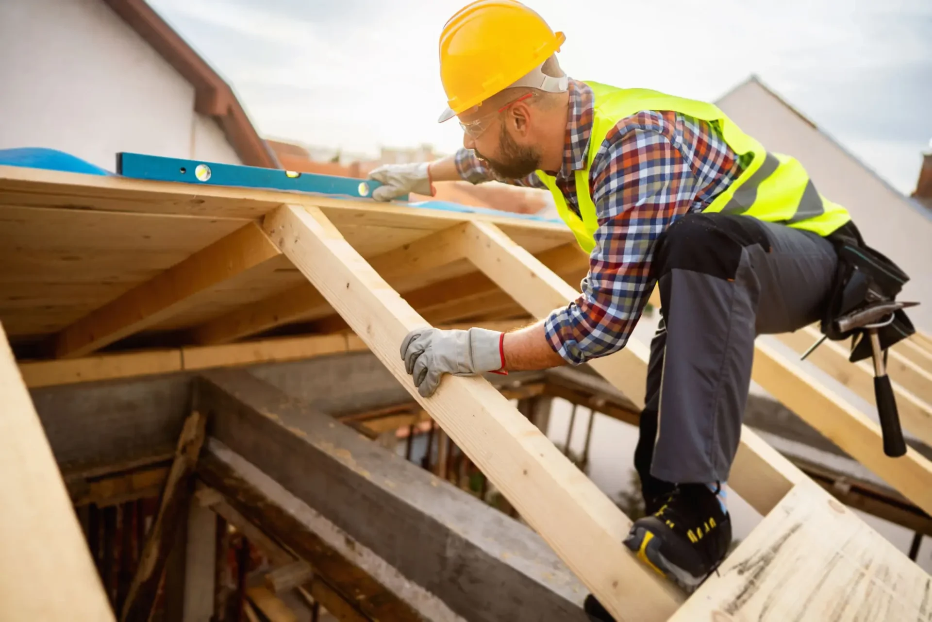 A technician performs roof repair on a damaged residential rooftop.